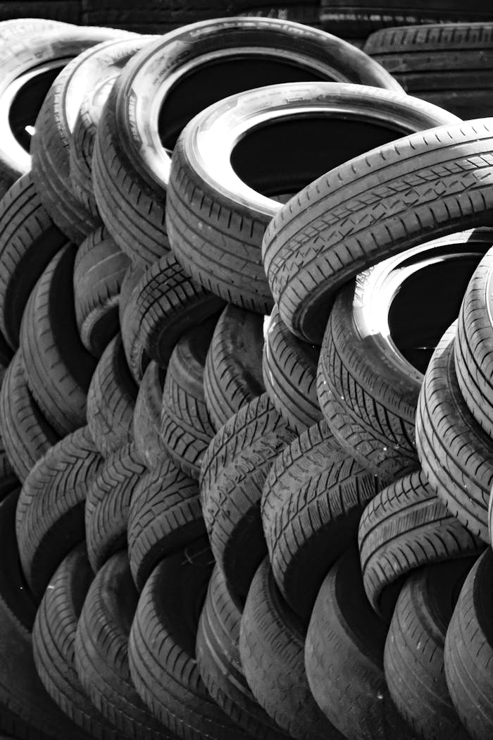 who-we-are Artistic black and white image of a stack of used tires outdoors. Perfect for recycling concepts.